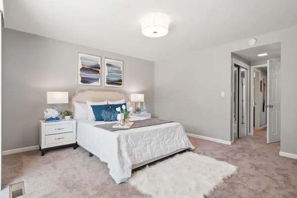 a bedroom with a bed and a lamp