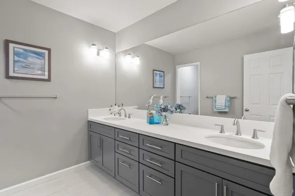 a bathroom with a double vanity sink and a mirror