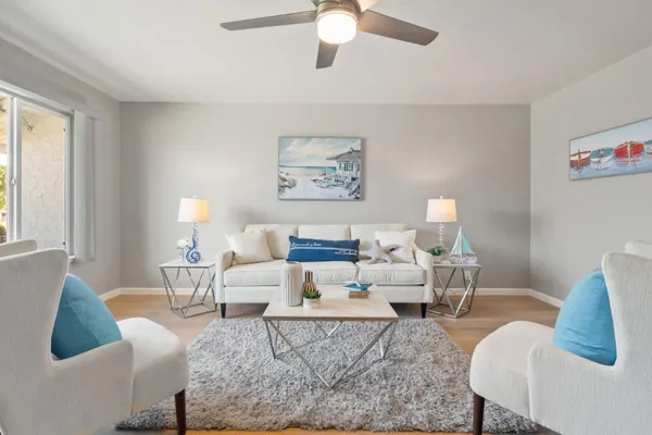 a living room with furniture or couch and a large window