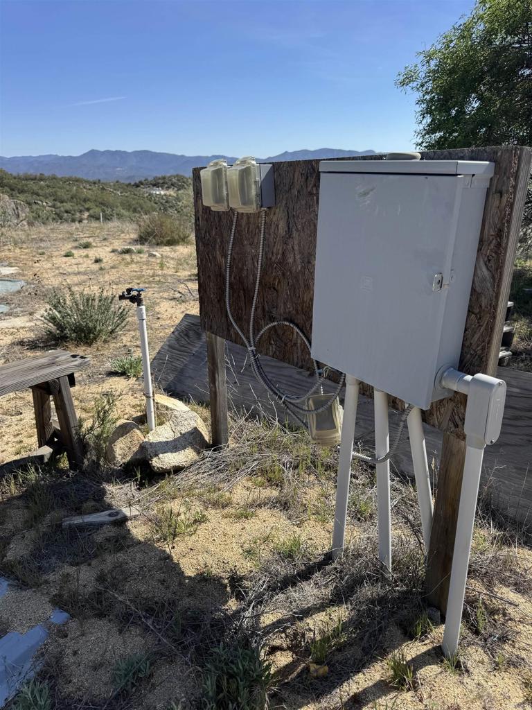 59775 Moonshine Trail Anza, CA 92539 - Photo 7 of 15 a view of a backyard with wooden floor and a floor to ceiling window