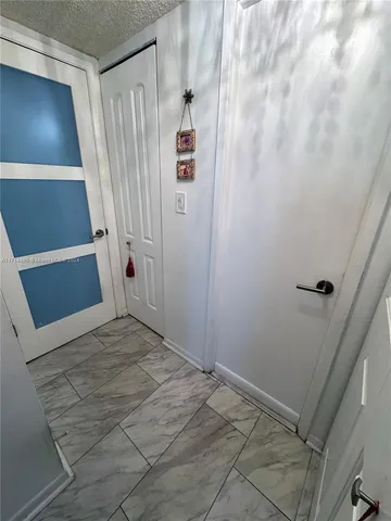 a bedroom with a bed and a flat tv screen on dresser