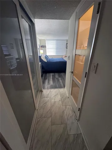 a large bedroom with a bed and wooden floor