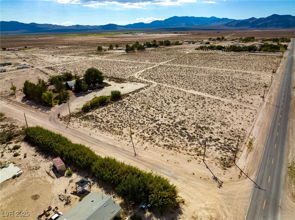 Marble Sandy Valley, NV 89019 - Photo 22 of 31 Birds eye view of property with a rural view, a mountain view, and view of desert
