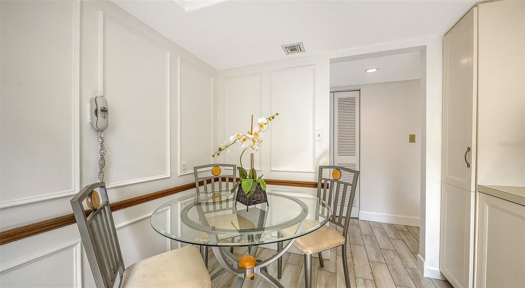 6287 Midnight Pass Road, Unit 103 Sarasota, FL 34242 - Photo 13 of 36 a dining room with table and chairs