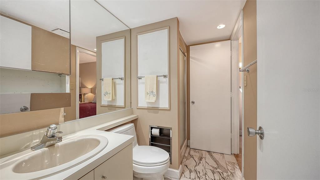 6287 Midnight Pass Road, Unit 103 Sarasota, FL 34242 - Photo 19 of 36 a bathroom with a sink a toilet and shower