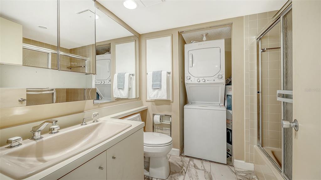 6287 Midnight Pass Road, Unit 103 Sarasota, FL 34242 - Photo 21 of 36 a bathroom with a sink a toilet and shower