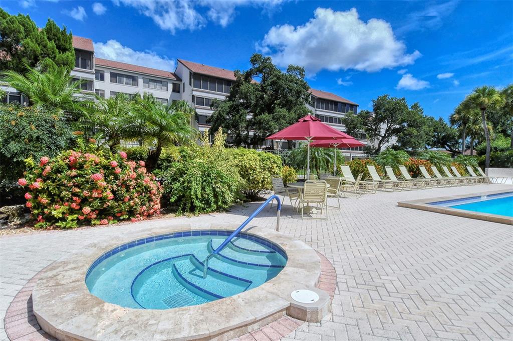 6287 Midnight Pass Road, Unit 103 Sarasota, FL 34242 - Photo 24 of 36 a view of a swimming pool with a patio
