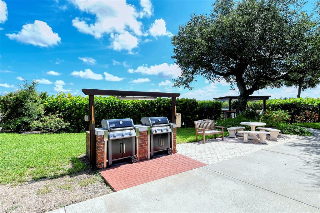 6287 Midnight Pass Road, Unit 103 Sarasota, FL 34242 - Photo 30 of 36 a view of a backyard with sitting area