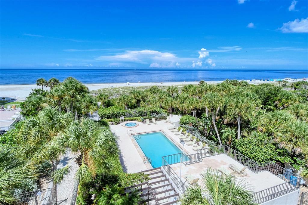 6287 Midnight Pass Road, Unit 103 Sarasota, FL 34242 - Photo 33 of 36 a view of a swimming pool with a yard