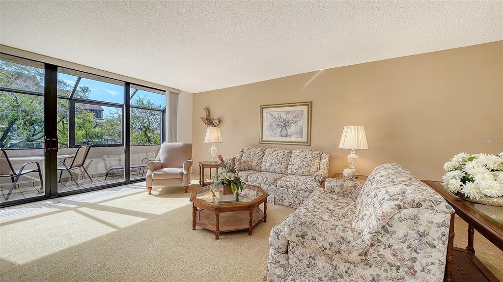 6287 Midnight Pass Road, Unit 103 Sarasota, FL 34242 - Photo 6 of 36 a living room with furniture and a large window