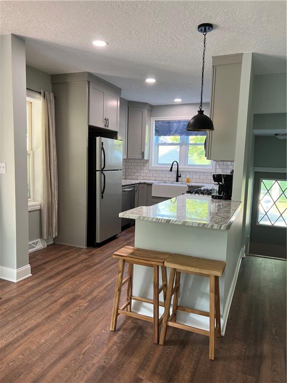 104 Bish Road Butler, PA 16002 - Photo 6 of 20 a kitchen with a table chairs refrigerator and microwave