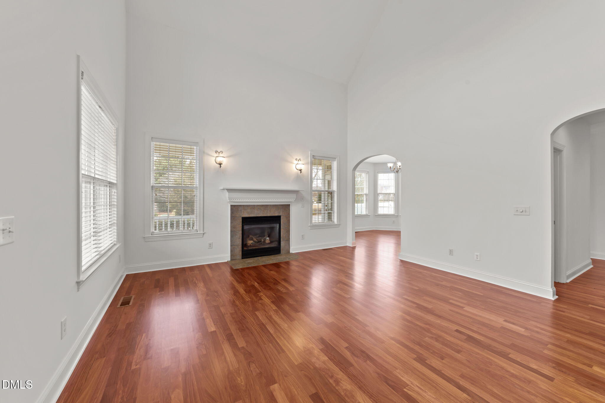 7101 Numa Circle Willow Spring, NC 27592 - Photo 7 of 44 an empty room with wooden floor fireplace and windows