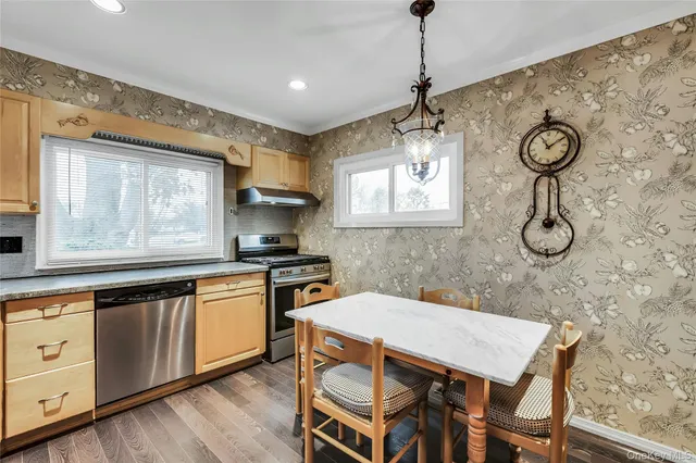 a kitchen with a table chairs stove and microwave