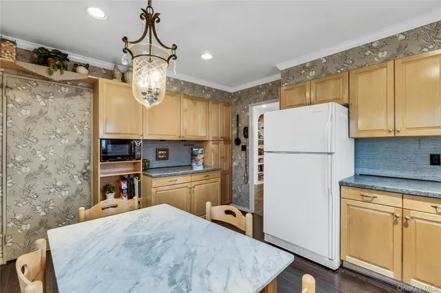 a kitchen with refrigerator cabinets and wooden floor