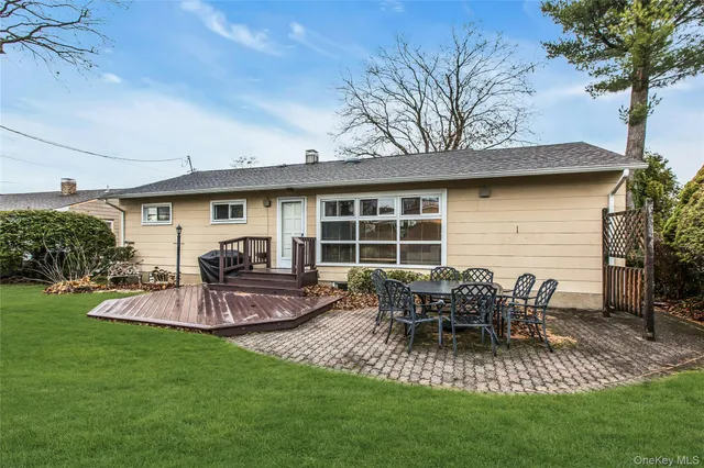 a view of a house with backyard and sitting area