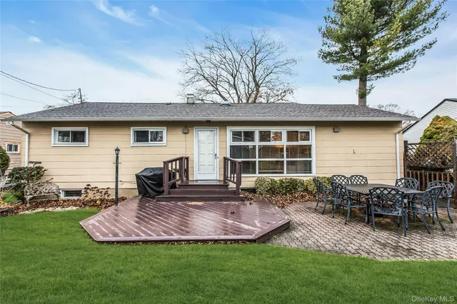 a front view of house with a garden and patio