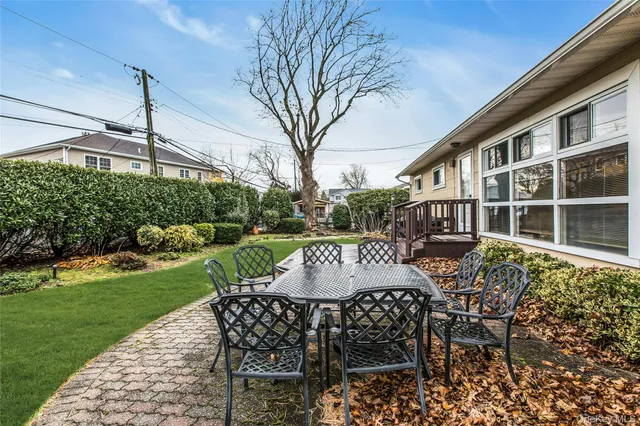 a view of a patio with table and chairs and potted plants