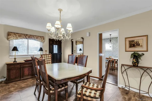 a view of a dining room with furniture and chandelier