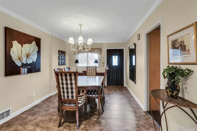 a view of a dining room with furniture and chandelier