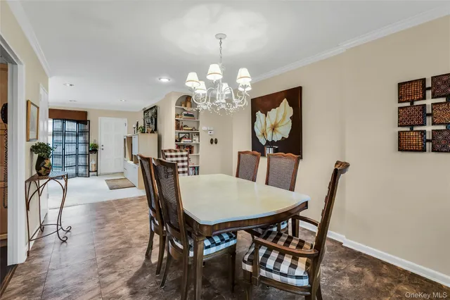 a view of a dining room with furniture and chandelier