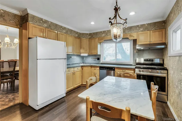 a kitchen with refrigerator a stove a sink and a refrigerator