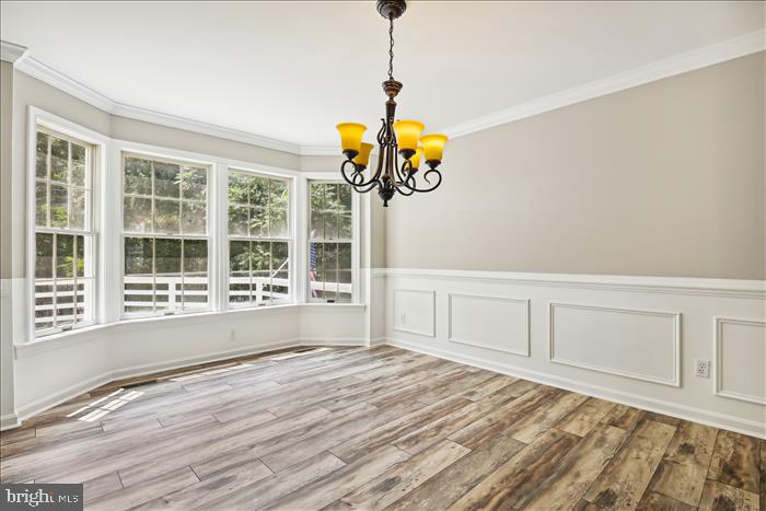 115 Kingbrook Road Linthicum Heights, MD 21090 - Photo 23 of 72 a view of an empty room with a window and wooden floor