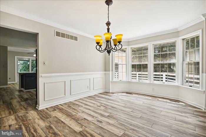 115 Kingbrook Road Linthicum Heights, MD 21090 - Photo 25 of 72 a view of an empty room with a window and wooden floor