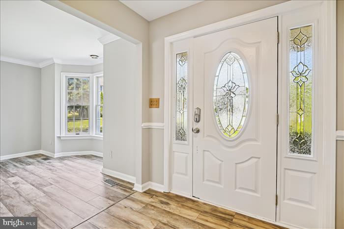 115 Kingbrook Road Linthicum Heights, MD 21090 - Photo 26 of 72 a view of a bedroom with wooden floor and windows