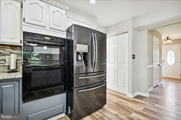 115 Kingbrook Road Linthicum Heights, MD 21090 - Photo 35 of 72 a kitchen with granite countertop stainless steel appliances and wooden floor