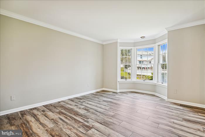 115 Kingbrook Road Linthicum Heights, MD 21090 - Photo 36 of 72 a view of empty room with wooden floor and fan