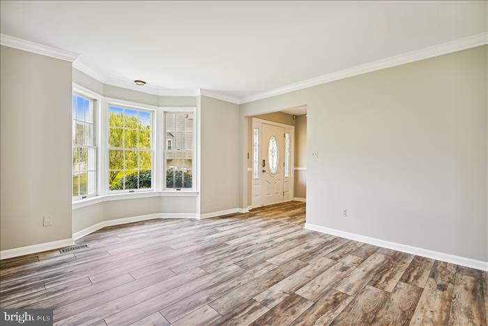 115 Kingbrook Road Linthicum Heights, MD 21090 - Photo 37 of 72 a view of an empty room with wooden floor and a window