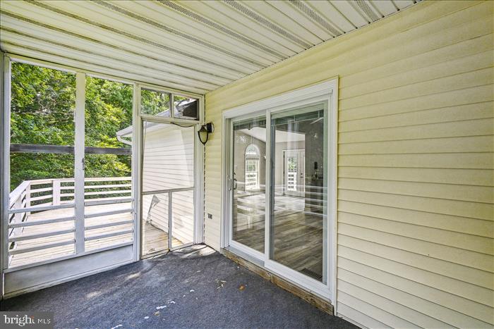 115 Kingbrook Road Linthicum Heights, MD 21090 - Photo 40 of 72 a view of a porch with wooden floor and fence