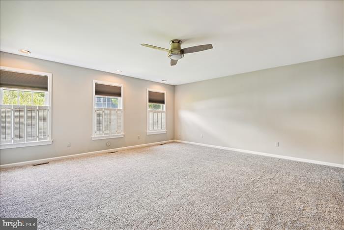 115 Kingbrook Road Linthicum Heights, MD 21090 - Photo 42 of 72 an empty room with windows and ceiling fan