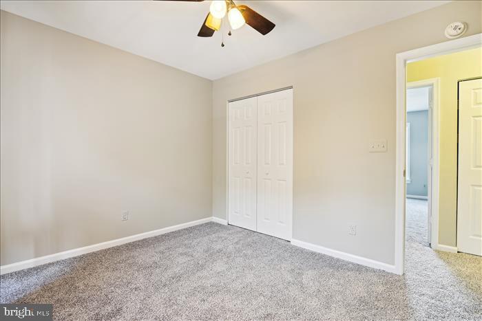 115 Kingbrook Road Linthicum Heights, MD 21090 - Photo 49 of 72 an empty room with a ceiling fan and carpet