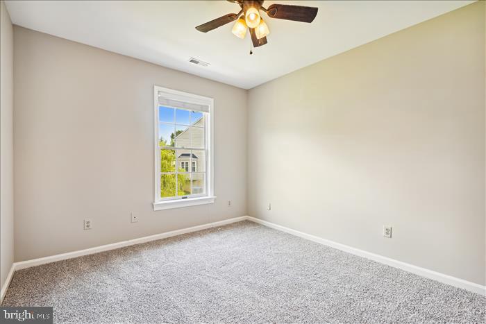 115 Kingbrook Road Linthicum Heights, MD 21090 - Photo 52 of 72 an empty room with a window and a fan