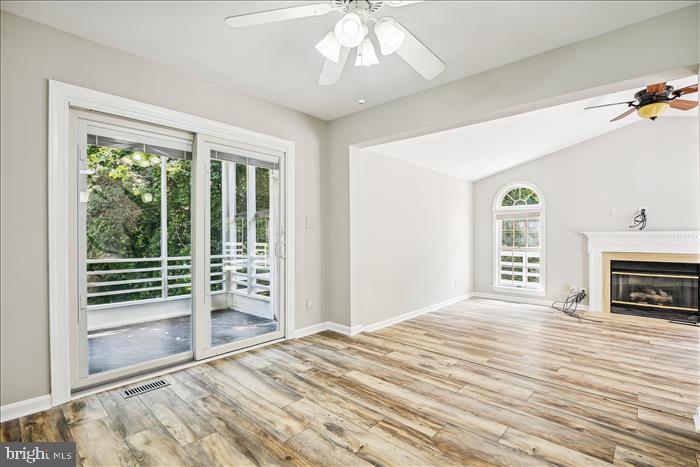 115 Kingbrook Road Linthicum Heights, MD 21090 - Photo 6 of 72 a view of a livingroom with wooden floor a ceiling fan and windows