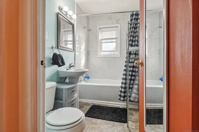 a bathroom with a toilet a sink and a bathtub