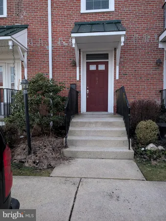 a front view of a house with potted plants
