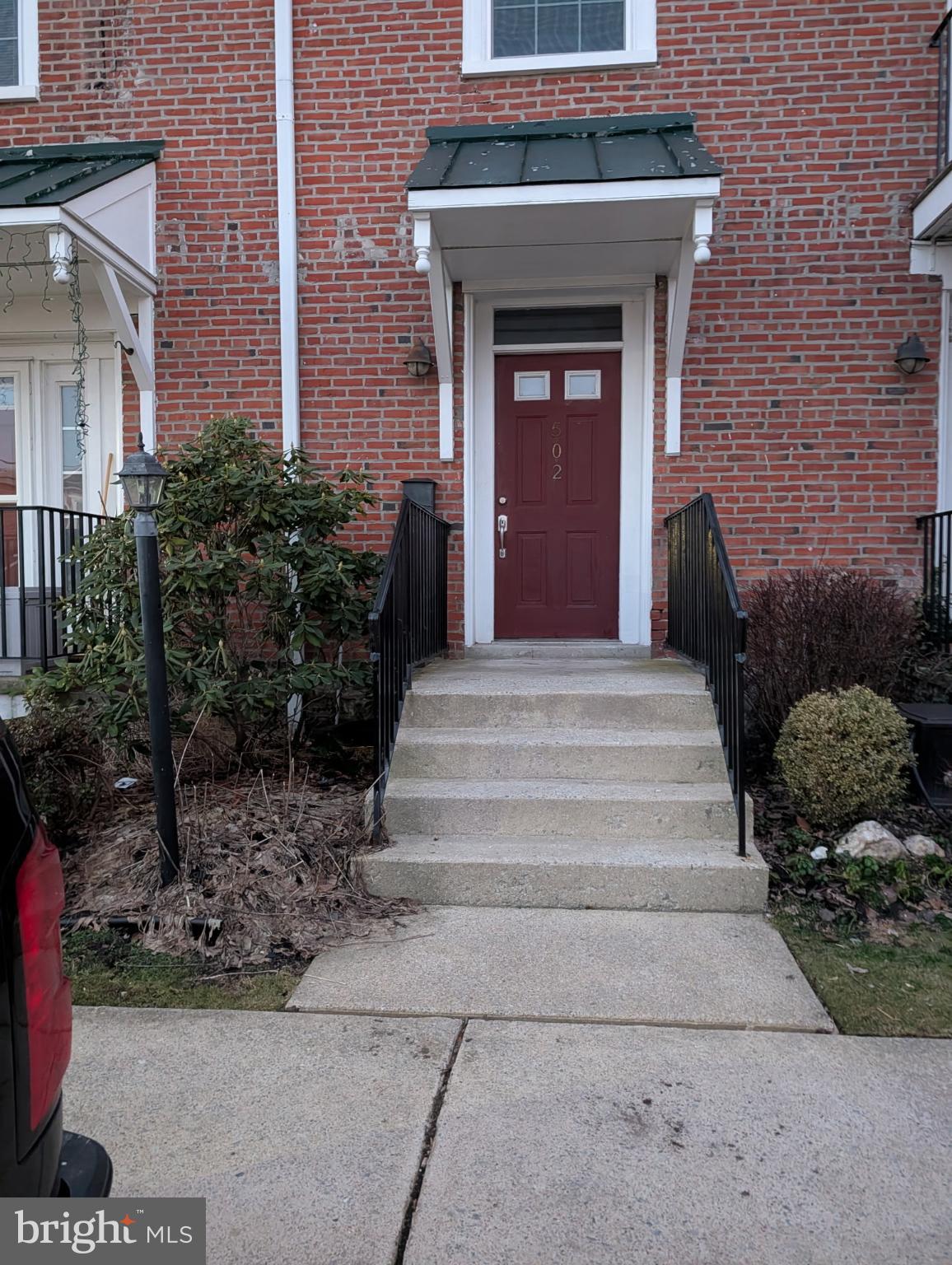 a front view of a house with potted plants