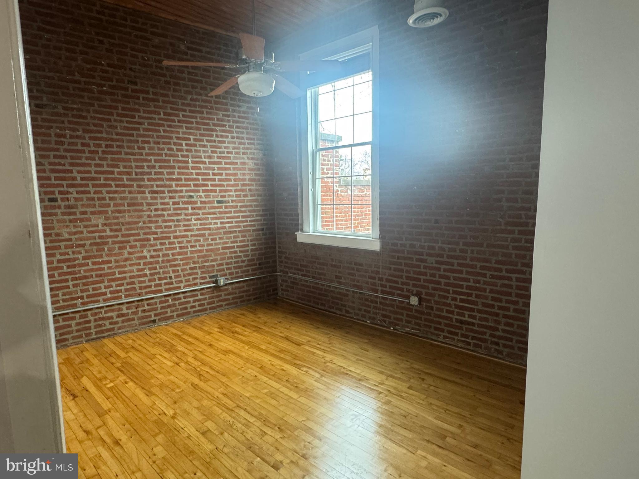 502 Keystone Alley, Unit 2 West Chester, PA 19382 - Photo 12 of 21 Charming brick-walled room with natural light.