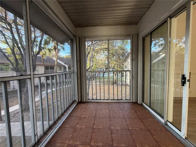 a view of a porch with wooden floor and outdoor space