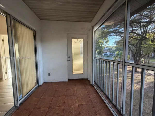 a view of a porch with wooden floor and stairs