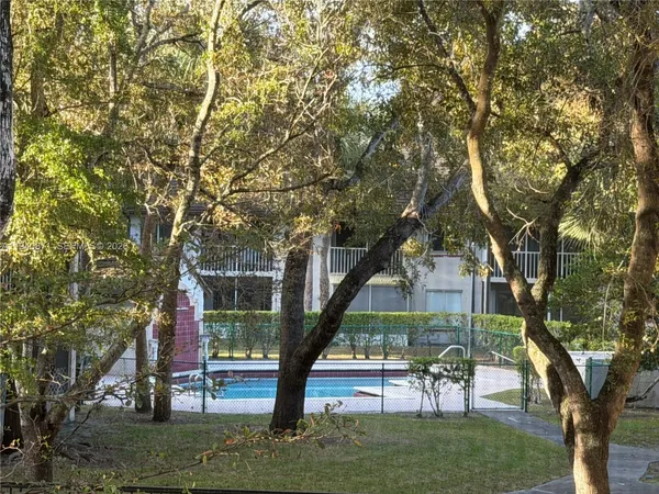 a wooden bench sitting in front of a tree