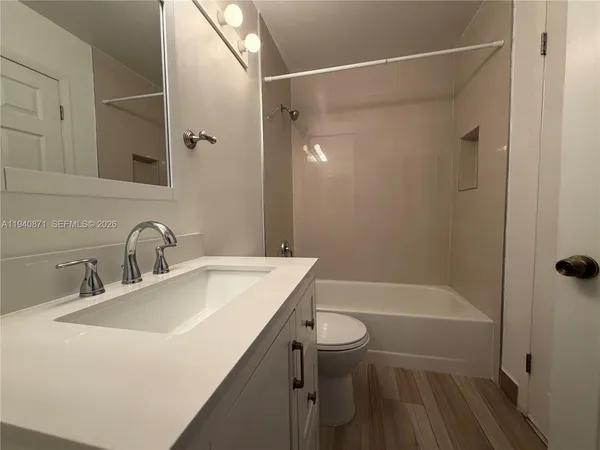 a bathroom with a sink a toilet and a bathtub