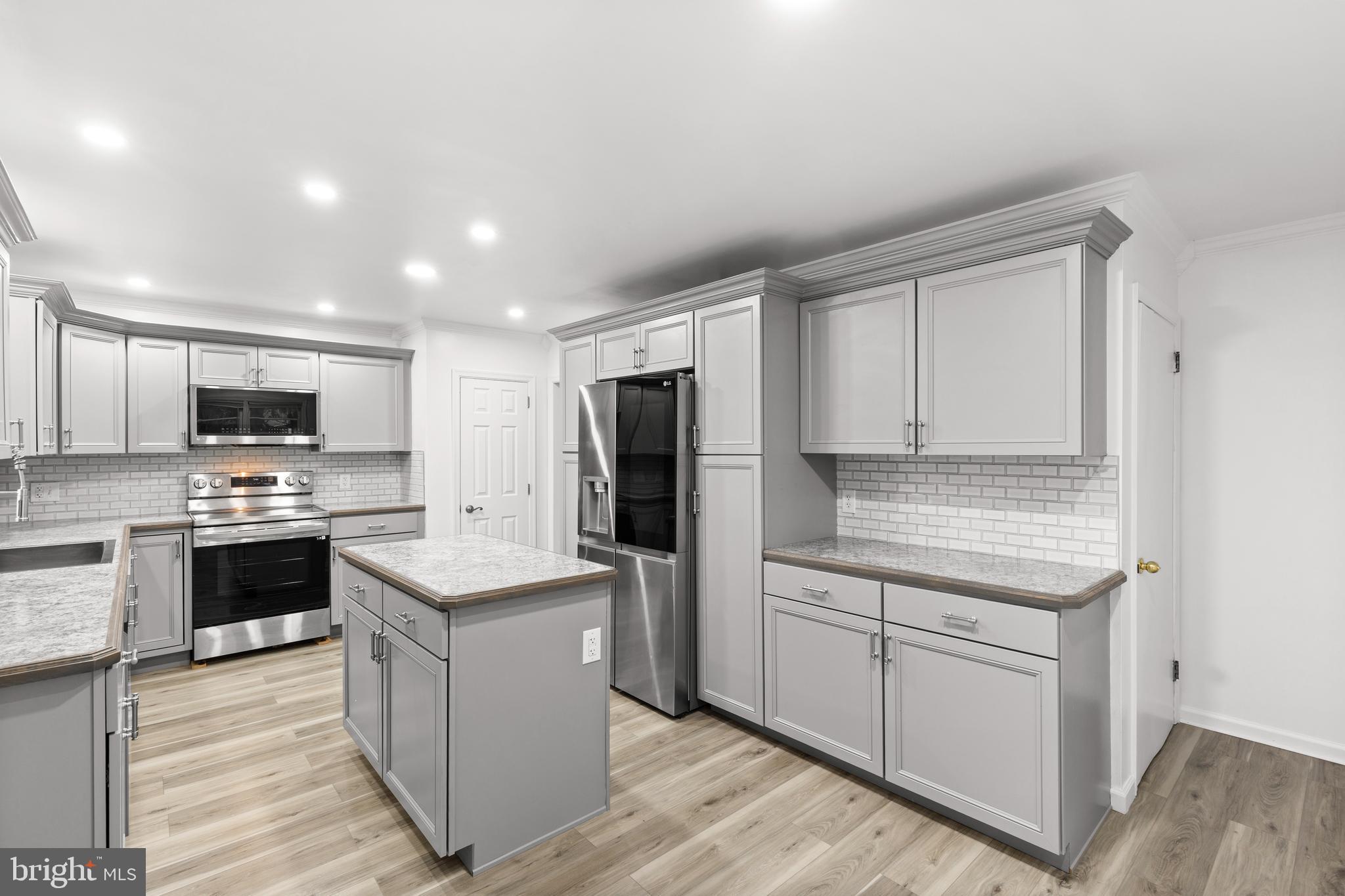 420 Stehman Church Road Millersville, PA 17551 - Photo 7 of 31 a kitchen with stainless steel appliances kitchen island granite countertop a stove top oven and refrigerator