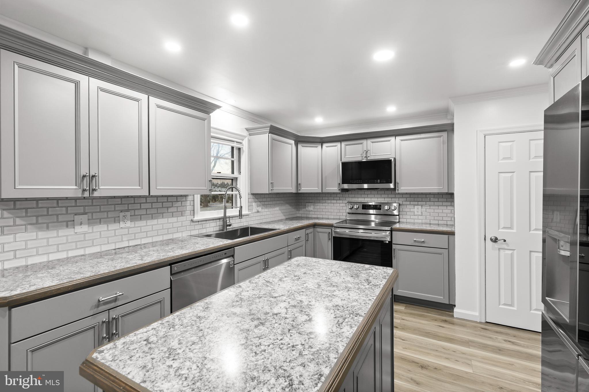 420 Stehman Church Road Millersville, PA 17551 - Photo 9 of 31 a kitchen with stainless steel appliances granite countertop a sink stove and refrigerator