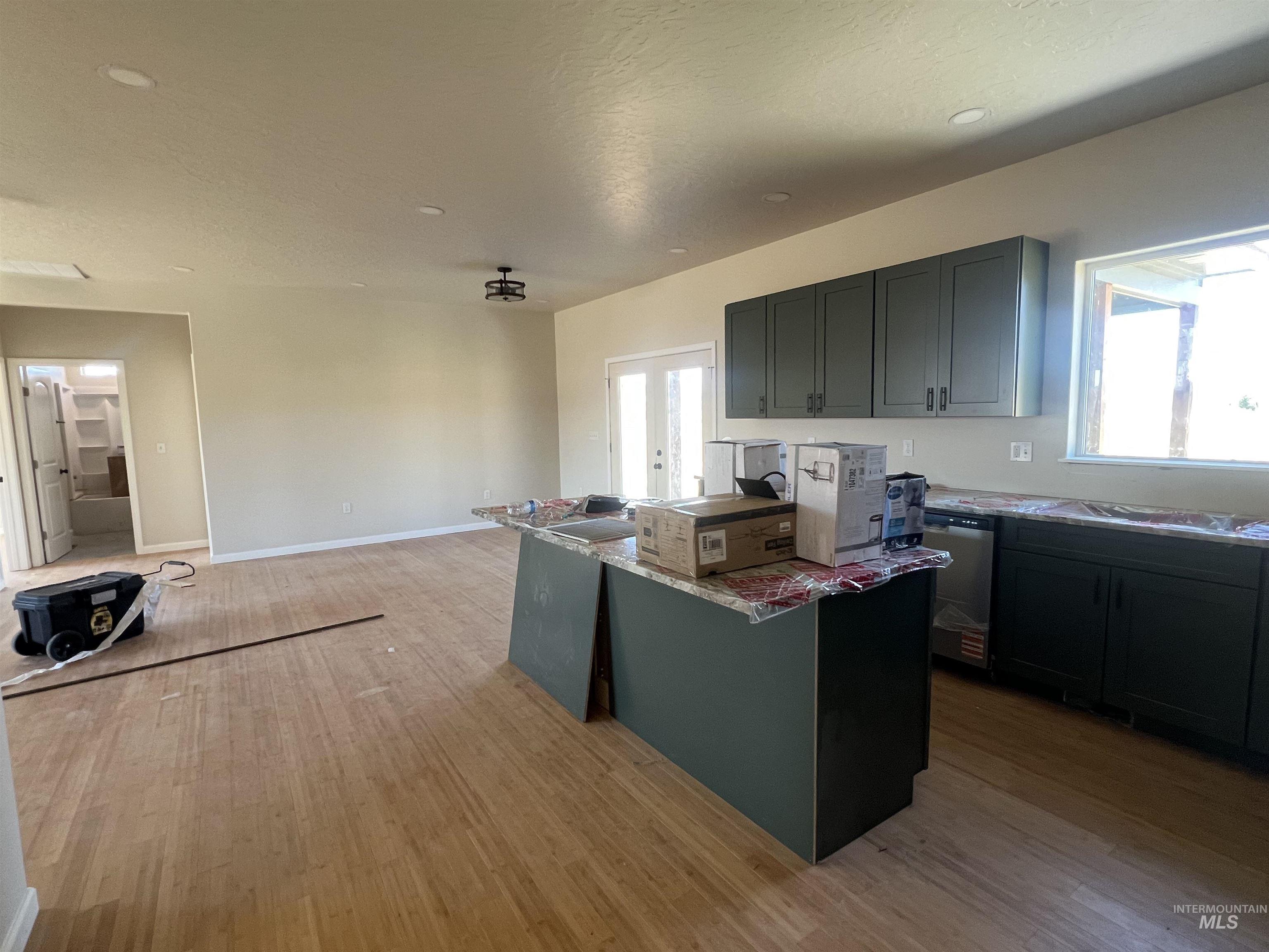 2300 Golf Council, ID 83612 - Photo 13 of 17 Open-concept kitchen and living area featuring wood-finish flooring, recessed lighting, and a contemporary ceiling fixture