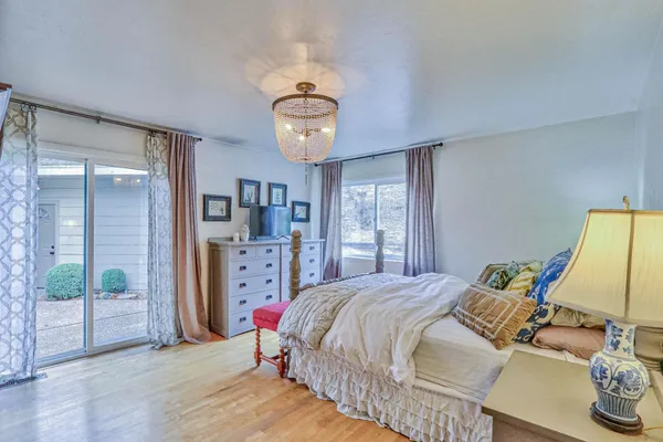 a bedroom with a bed and a large window