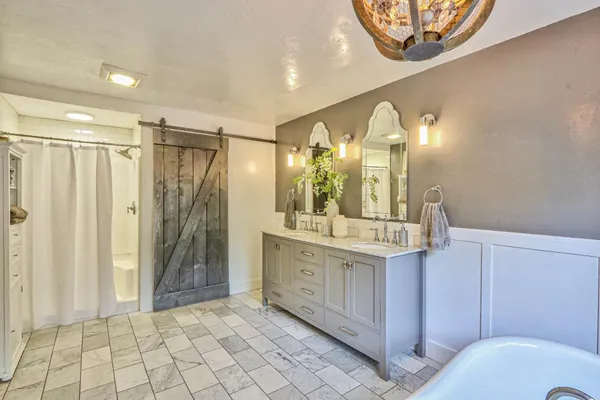 a bathroom with a mirror a sink and a shower