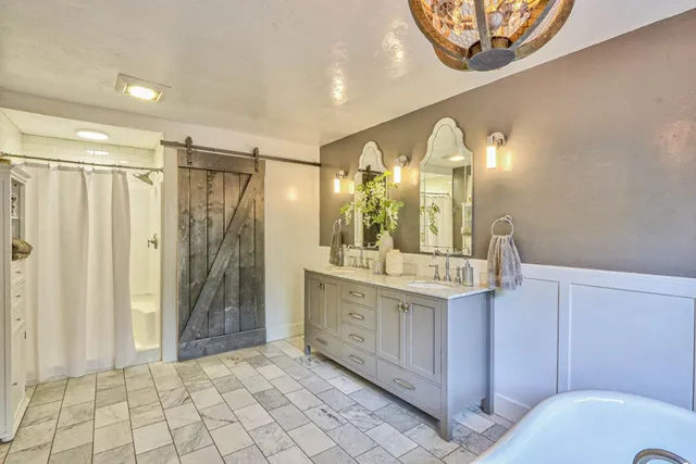 a bathroom with a mirror a sink and a shower